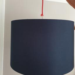 A large, navy blue 'drum' lamp shade I purchased approx. 2 years ago from Peter Jones [ John Lewis ]. Lining in red and ceiling fitting is included.

The width is 45cm and the height is 29cm.

The shade has no creases at all !

It was previously hung within a ceiling rose and I searched high and low for anything but a gold or plain lining. The red is pleasing. May also be suitable for a free standing floor lamp.

Location : Morden, S W London
