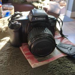 canon EOS 1000f camera with camera battery also comes with carry bag it's got 35mm to 80mm lens and you can have it on automatic focus or Manuel focus and build in flash plus led screen.