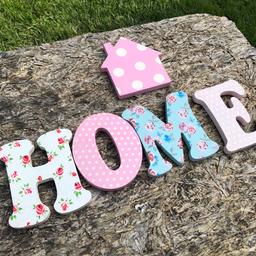 Next home letters . Individual letters spell home and a cute little house to go with it. Littl hooks on each piece to hang on the wall. Pretty pastel colours spots and florals . Lovely item .