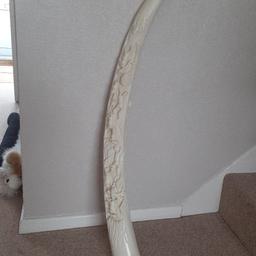 Carved horn, synthetic, horses on one side and Chinese houses on other. length is 3ft around the curvature. Collection only