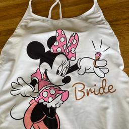 Disney - Minnie Mouse “ Bride “ swimsuit .
Size 14 
Immaculate- white , fully lined , inner structured bra top , cross over straps .
Bride is written in glittery writing.
Worn only once at a spa afternoon before the wedding.
No marks , no pulls , clean - been laundered .
As new