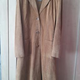 vintage from oasis bought about 35.years.ago and never worn just been in coat bag midi length tan colour suede looks beautiful on has criss cross detail and two pockets at front rrp£325. sorry these pictures are not great they are showing colour as a bit patchy but it's not the coat looks brand new no fading in colour it's the pictures