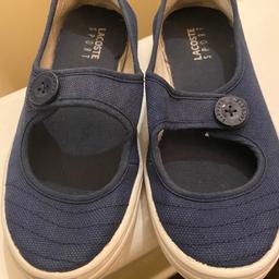 Girls navy blue Lacoste shoes . Coe from a pet and smoke free home . Worn a few times . Still has plenty of wear . Worn but in good condition .