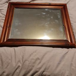 Brown frame mirror size 22 inches wide. 25 inches wide. in good condition