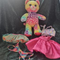 This is a lovely bear press the hand and Sings the carebear 🎵 song. Comes with a denim look dress, a nice pink dress a tutu, and a bikini top which is Sparkly