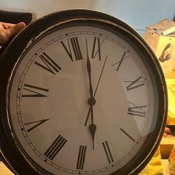 Large clock. Black and gold in colour. Lovely vintage design.