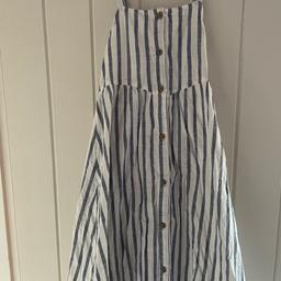 Brand new without tags! Never got chance to wear it. Striped white and blue cotton dress. Beautiful. Crosses at the back age 8