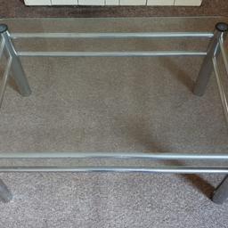 a glass coffee table with steel legs that measures:
35.4 inches in length
23.6 inches wide
15.4 inches tall.