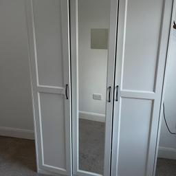 White wardrobe with attached mirror and shelves