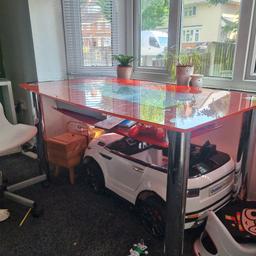 large red glass dining table. no chairs hench the price. can sit 6 people.
