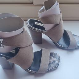 Brand new, unworn with labels still attached to the soles. No box. Suedette mules with ankle strap fasten. Heel height is 9cm (3.5in). Excellent condition.