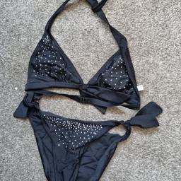 Ladies Bikini - Size 10. Black with diamonte on bikini top and bottom. Worn twice but lots of wear left. Has been washed and placed in storage. One of the inside bra pads missing. Nice cute bikini for your summer hols!