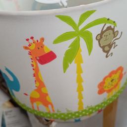 Lampshade with animal decoration and palm trees with stars around the bottom