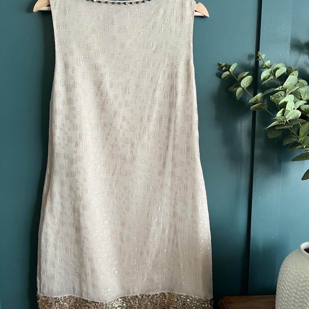 Cute little dress - hardly worn so in really good condition. Worth mentioning that the neckline embellishments have become loose - can do with a stitch or 2 to strengthen and keep in place. Apart from this in really good condition.