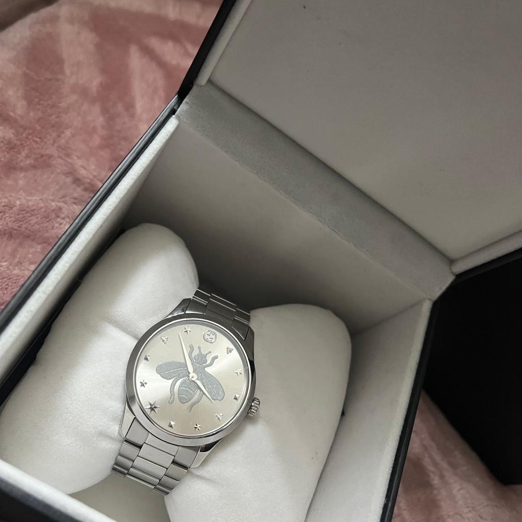Gucci watch. Never worn. Still in box and comes with certificate. Shows proof of purchase.