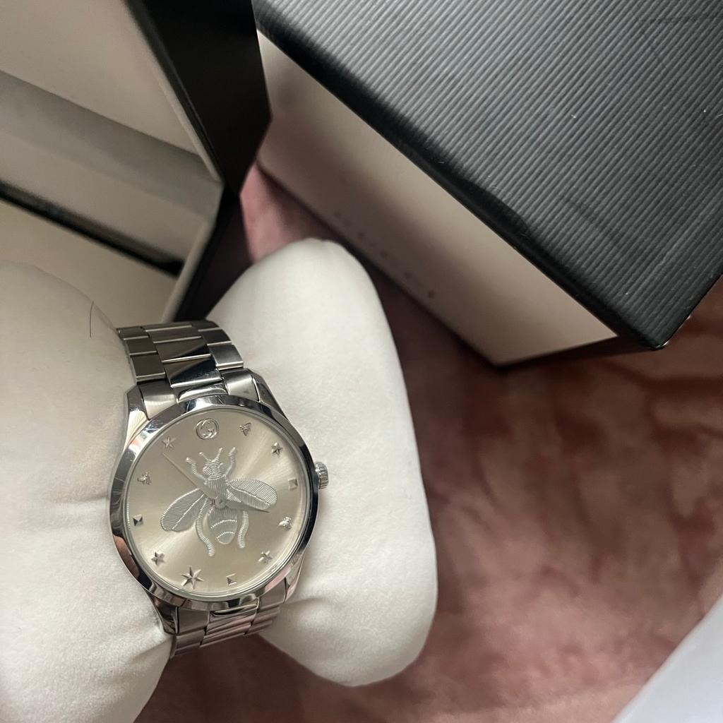 Gucci watch. Never worn. Still in box and comes with certificate. Shows proof of purchase.