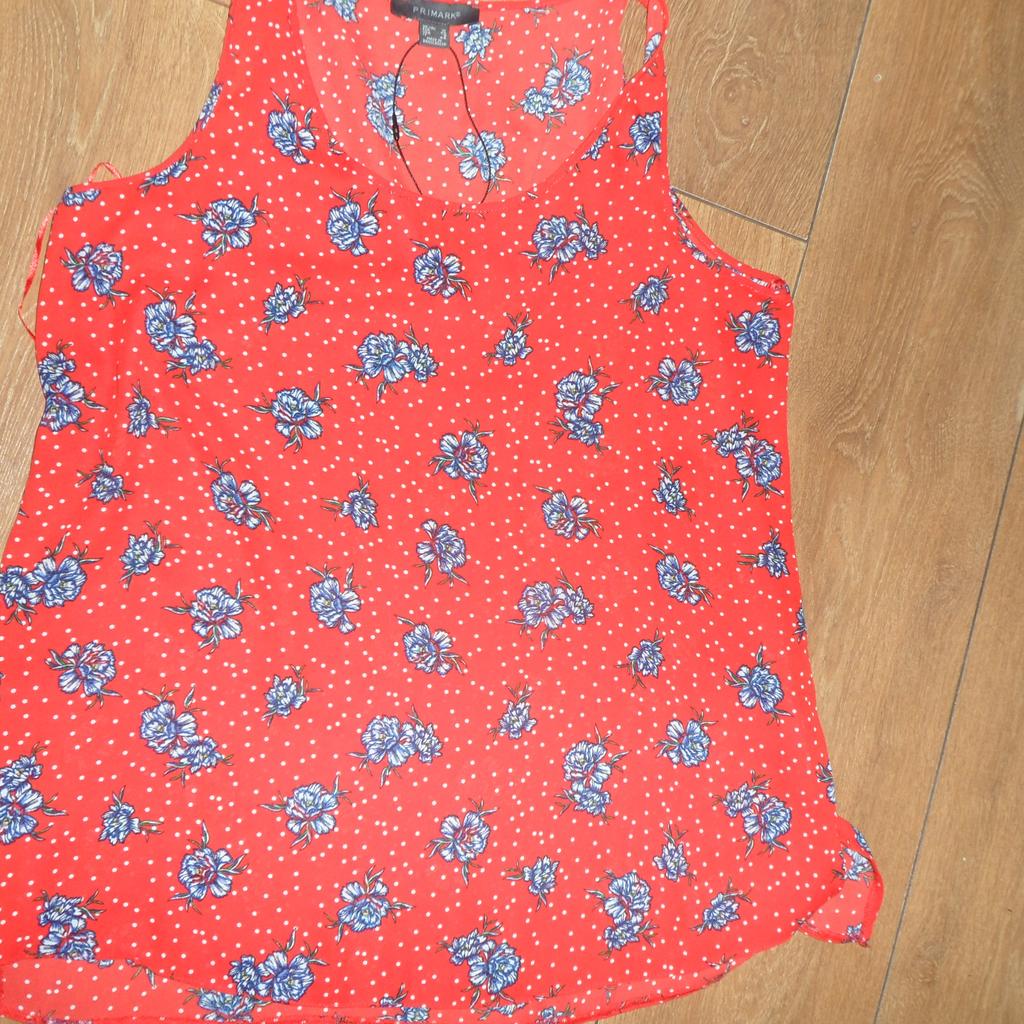 A RED FLOWERY SLEEVELESS BLOUSE SIZE 12. PICK UP FROM M40 1NS