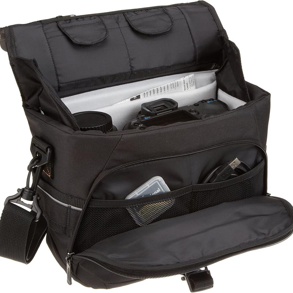 DSLR Gadget Messenger Bag, Black With Grey Interior

DSLR Gadget Shoulder Bag Large Camera Accessories Basic Messenger
Modern Elegant
Black Messenger Bag with Grey Interior:

Store, carry and protect your camera equipment
Compartment for iPad Mini, Google Nexus 7 and Amazon Kindle Fire
Holds 1 DSLR camera body and 2 lenses
Internal Dimensions: 10.2" x 3.7" x 6.8" (LxWxH)
External Dimensions: 11.6" x 4.9" x 7.8" (LxWxH)
The Amazon Basics Medium DSLR Gadget Bag is a must have for carrying your DSLR camera, lenses,
and other camera accessories.
No matter what equipment you use, the removable interior of the Amazon Basics backpack can be
adjusted to fit a DSLR camera body, two lenses, and other accessories.
The large gadget bag features a padded slot that is able to fit iPad mini, Kindle Fire, Google Nexus 7, and other small devices. Additional pockets in the front offer a space for a cell phone and other electronics and accessories