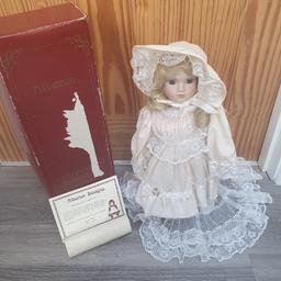 The House of Valentina Collection Porcelain doll "Laura".The doll has been stored in the original box and includes the stand and original tags.