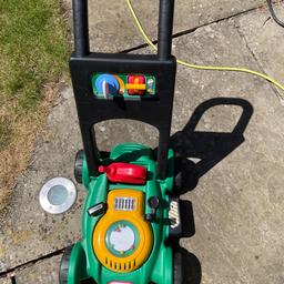 Role play: mowing the lawn. Push along toy mower.  Used but good condition.
