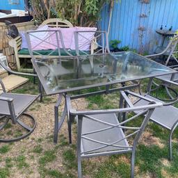 Lovely large garden set , comprising of large garden glass table on metal base (lifts off for transportation), 168 cm by 102 cm, six large chairs , two of which have a swivel base , the others are stackable when not in use
