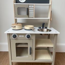 Wooden play kitchen has an oven, stove, microwave and a removable steel sink. The cabinet doors open and close and the oven knobs are clickable. Comes with a set of five utensils. Dimensions: W54 x D30 x H89 cm.
Excellent condition. Collection only.