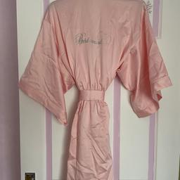 Rose pink bridesmaid robe with “Bridesmaid” in silver gems and a silver sparkle heart. Size 12 - 14. Comes in a gift box. Never been worn still has tags on