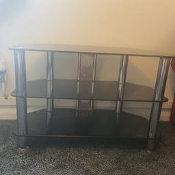 black tempered glass solid TV stand in excellent condition - barely used 
quite heavy only £20 (can drop off if local)