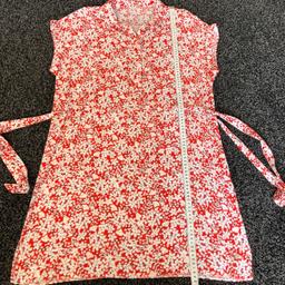 Lovely summer, soft cotton Red & White Floral Shirt Dress with fully adjustable tie waist at both sides, button fastening at top, sleeveless and small collar, also has small split at both sides at hem.

UK Size 12/14 length from shoulder to hem is 89 cms

As New only worn twice!

From Smoke Free/Pet Free very clean home