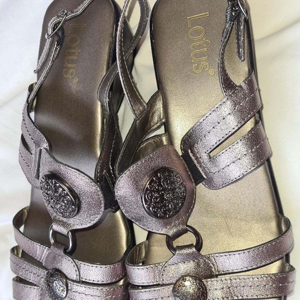 Ladies Lotus Silver Low Heeled Sandals Uk 7 1st 2c Will Buy. See photos for condition size flaws materials etc. I can offer try before you buy option if you are local but if viewing on an auction site viewing STRICTLY prior to end of auction.  If you bid and win it's yours. Cash on collection or post at extra cost which is £4.55 Royal Mail second class. I can offer free local delivery within five miles of my postcode which is LS104NF. Listed on five other sites so it may end abruptly. Don't be disappointed. Any questions please ask and I will answer asap.