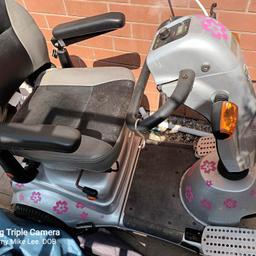 Quingo disability scooter for sale.  Comes complete with key and charger.  Good running order with batteries fully charged every 2 weeks.
The pink flower stickers can be easily peeled off.
Described as fair condition because one foot pedal is slightly higher than the other.
Has been kept in the garden under cover all the time.
Takes weight up to 22 stones and goes for 10 miles on full charge.
Selling as need a smaller one.
Must be collected from Bilston WV14 7BD as have no transport.