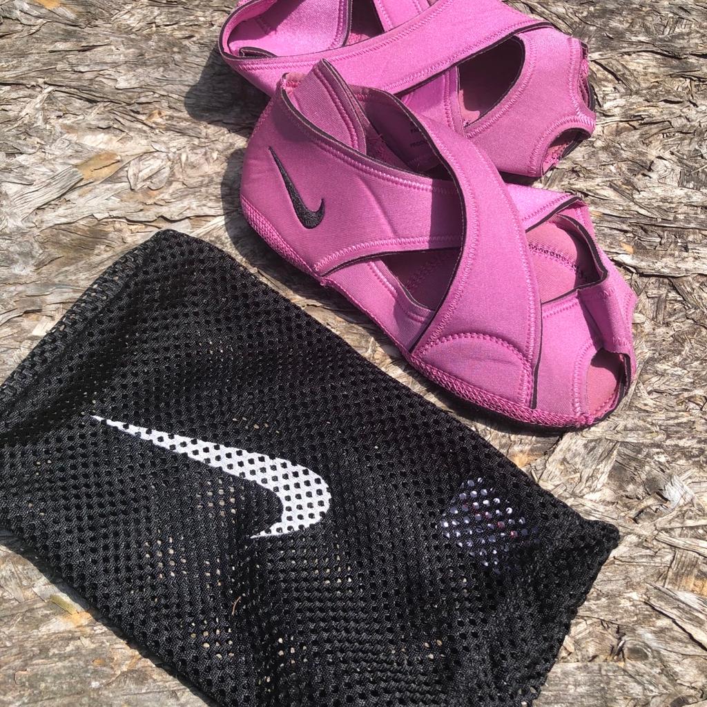 Nike studio wrap yoga dance shoes . Fit up to a 7 . Pink strappy soft shoes with non slip sole. Great for dance yoga Pilates etc . Come in mesh bag . Great shoes .