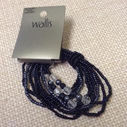 10 Strand expandable Bracelet, strung with Black, Grey and Clear beads, from wallis.

New, Unused with Tag in excellent condition and from a smoke free home.

Buy with other Listed Items for a Bundle Price reduction.
