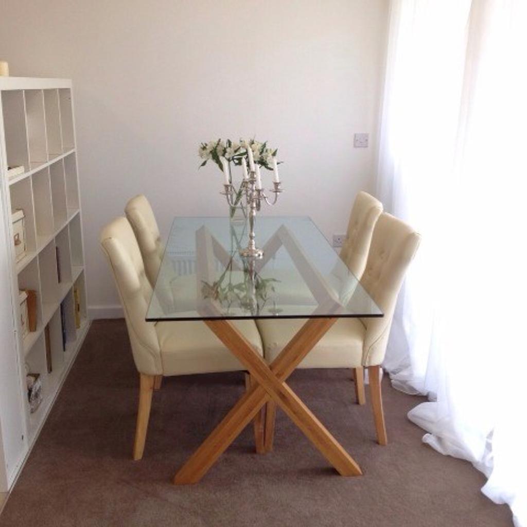Glass dining table with cream leather chairs in E1 London for £100.00