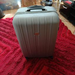 a large sliver suitcase all ok inside and out  for storage