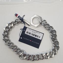 New with tags, plastic bag / foil but no gift box

Brand Tommy Hilfiger Jewellery
Model number	2790164
Model name Toggle Chain
Chain Type Curb
Gender Gents
Material Stainless steel
Circumference 19 / 21cm ~ 7.5 inches
Total Metal Weight	31.6 Grams
Resizable	No
Model Year	2019
Closure Toggle clasp / T-bar
Finish Brushed with logo

Gents Tommy Hilfiger Toggle Logo Stainless Steel Bracelet with the signature branding.
Perfect for layering with your watch, to complete the smart casual look.

#startfresh

Crafted in stainless steel, this robust chain bracelet is perfect for everyday wear.
The chunky bracelet features a toggle fastening adorned with a red, white and blue stripe detail.