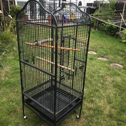 Large Bird cage for parrots or birds. Has a pull out tray for easy cleaning. It’s a trolley cage so can be moved around easily. See last photograph for cage measurements.