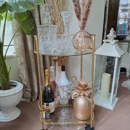STUNNING DRINKS TROLLEY GOLD IN COLOUR WITH GLASS SHELVES  BRAND NEW BROUGHT FROM AMAZON FOR.£40.00  DID NOT FIT WERE I WANTED IT TO GO ITEMS NOT INCLUDED