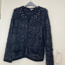 Fluffy black and silver cardigan with bead and diamanté detail to front and back if neck line. No tags but never been worn. Please see all photos for details. Black colour is darker than first photo suggests. If you require posting please ask first using the question option. Thanks very much.