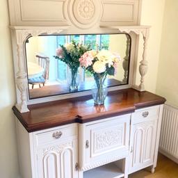 Beautiful painted antique buffet/chiffonier with mirror in great condition! Handmade. Nice carved detailing.

Painted with Frenchic ‘Stone Rosie’. Has been sanded, painted and revarnished with a ultra tough varnish so it can be wiped with a damp cloth. Top and base are exactly the same colour but the top was in the shade so looks darker in the photo.

Measures: Height: 210cms, (Height of base: 95cms), Width: 152cms, Depth: 20”/51cms.