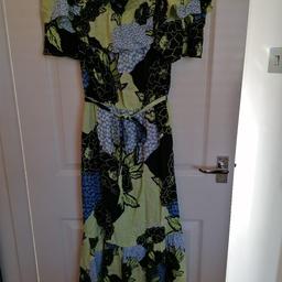 Absolutely gorgeous tiered maxi dress with tie waist fastening.. Ruffle edging on the neck line.. Bardot style.. Side pockets... Can be worn with or without straps.. ( spare included).. SIZE 6 petite. Elasticated at the waist