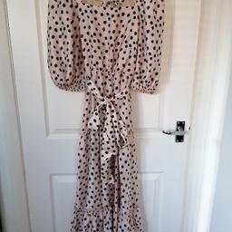 Gorgeous nude polkadot tiered maxi dress. Elasticated at the waist. Tie fastening at the waist.. Elasticated at the shoulders.. Puff sleeves with elasticated cuffs.. Bow tie fastening at the backneck.. With fixed wrap detail at the back.. Lovely summer dress.. Was £45