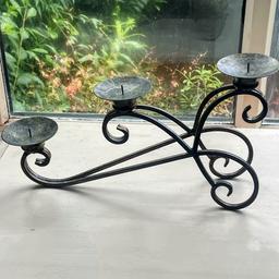 Beautiful wrought iron candle holder for indoor or as a decorative garden accessory.