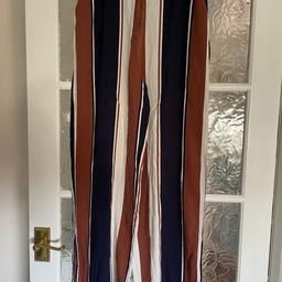 Women’s loose fit trousers size 10.  Brown, Blue and Cream stripes.  Side pockets.  Zip up fly and two hook.  Loose fit.  Part elastic waist .    Side vents on legs.  Wear on hooks.