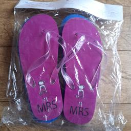 BRAND NEW IN PACKAGING!

Mr & Mrs flip-flops.
Size UK 8-12

One pink pair and one blue pair.

Perfect wedding gift.

Leaves an imprint when walking on sand/beach with Mr/Mrs with love hearts (see last image)

Collection from Marske.

Please check out my other items for sale. Having a clear out.