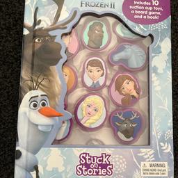 Disney Frozen 2 stuck on Stories book. Includes 10 suction cup toys a board game and story book. Used but still in a good condition