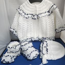 A beautiful handknitted set. This is size 0-6 months. A beautiful matinee coat, bonnet and booties. Pretty lacey outfit for little girl