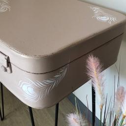 Upcycled vintage suitcase on tall hairpin legs. The legs are superior quality ones.
Painted in Frenchic quality chalk paint, lightly distressed with added feather detail. Glitter detail in the paint so it sparkles in the dark.
NB-being a vintage suitcase, one of the latches does not work 100% but isn’t really a problem just wanted to mention it.
Dimensions 89cms H 61cms W 47cms D