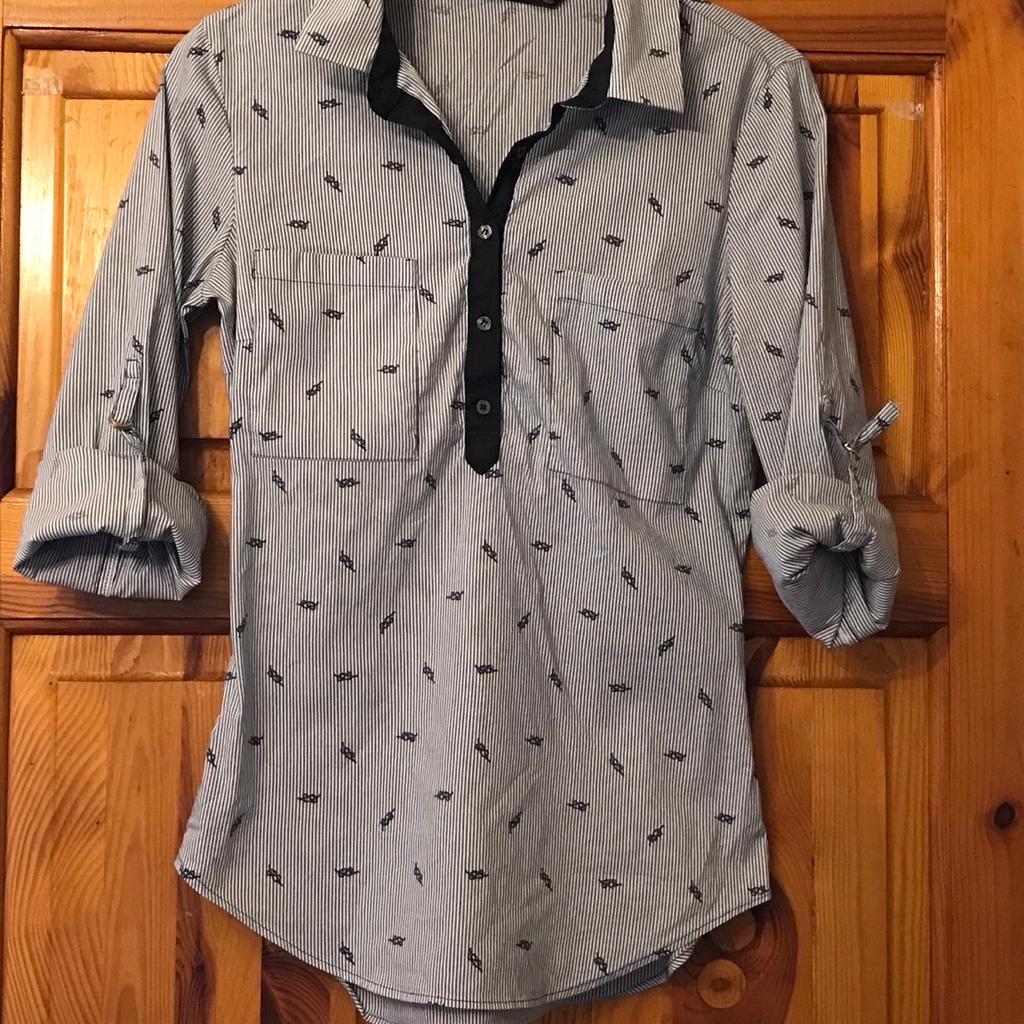 Beautiful zara shirt can be worn long or short on the sleeves as per picture

Size S