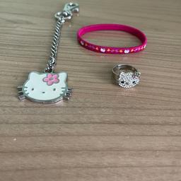 Hello Kitty Accessories Bundle. 

The bundle contains:

- Brand New pink hair tie
- Hello Kitty Key chain / attacher
- Used Hello Kitty adjustable ring (2 missing stones on the bow)  

#HelloKitty #hellokittyring